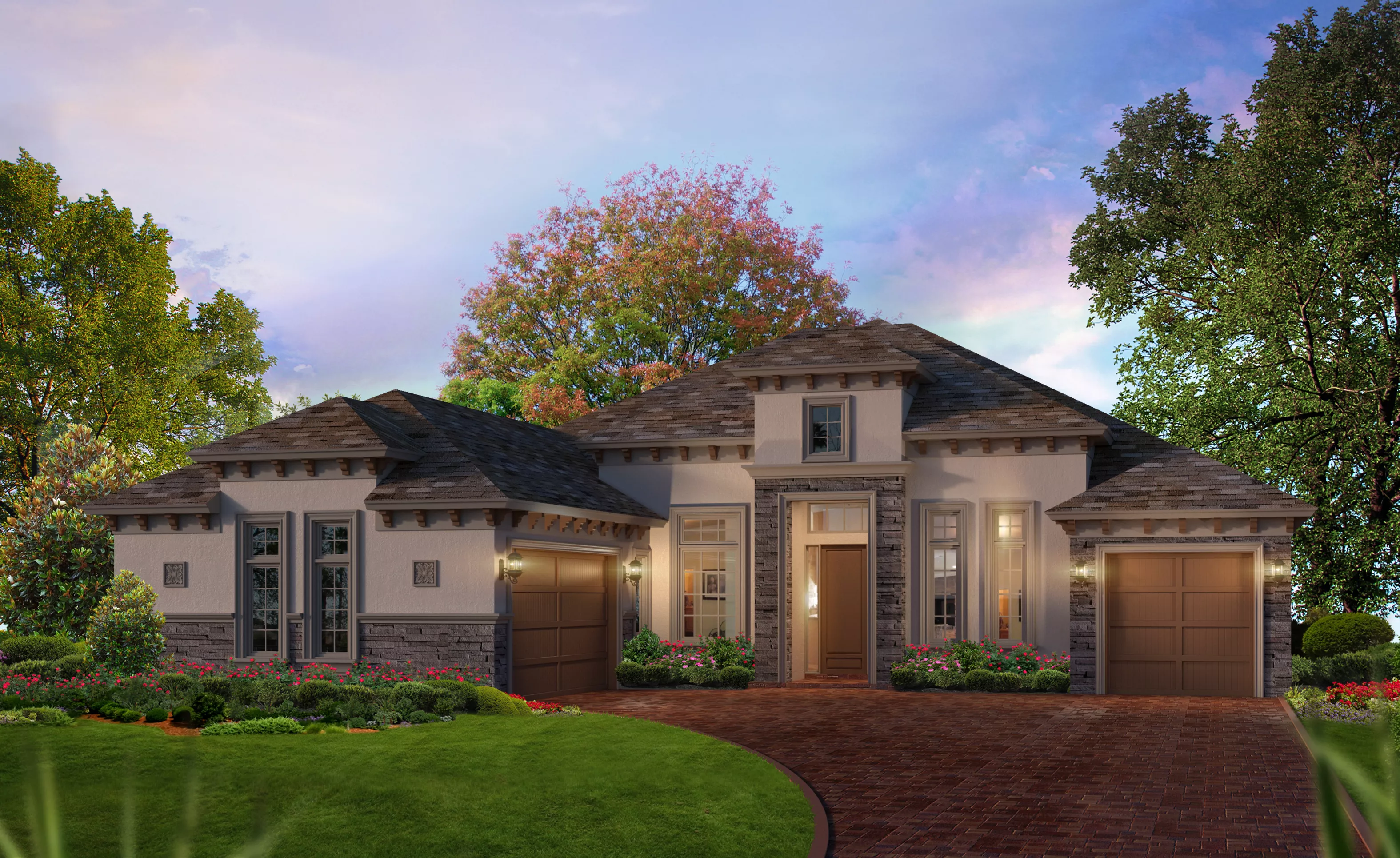 Tuscan exterior of the Egret VII home featuring a stucco facade, stone accents, two-car garage, and a brick paver driveway.