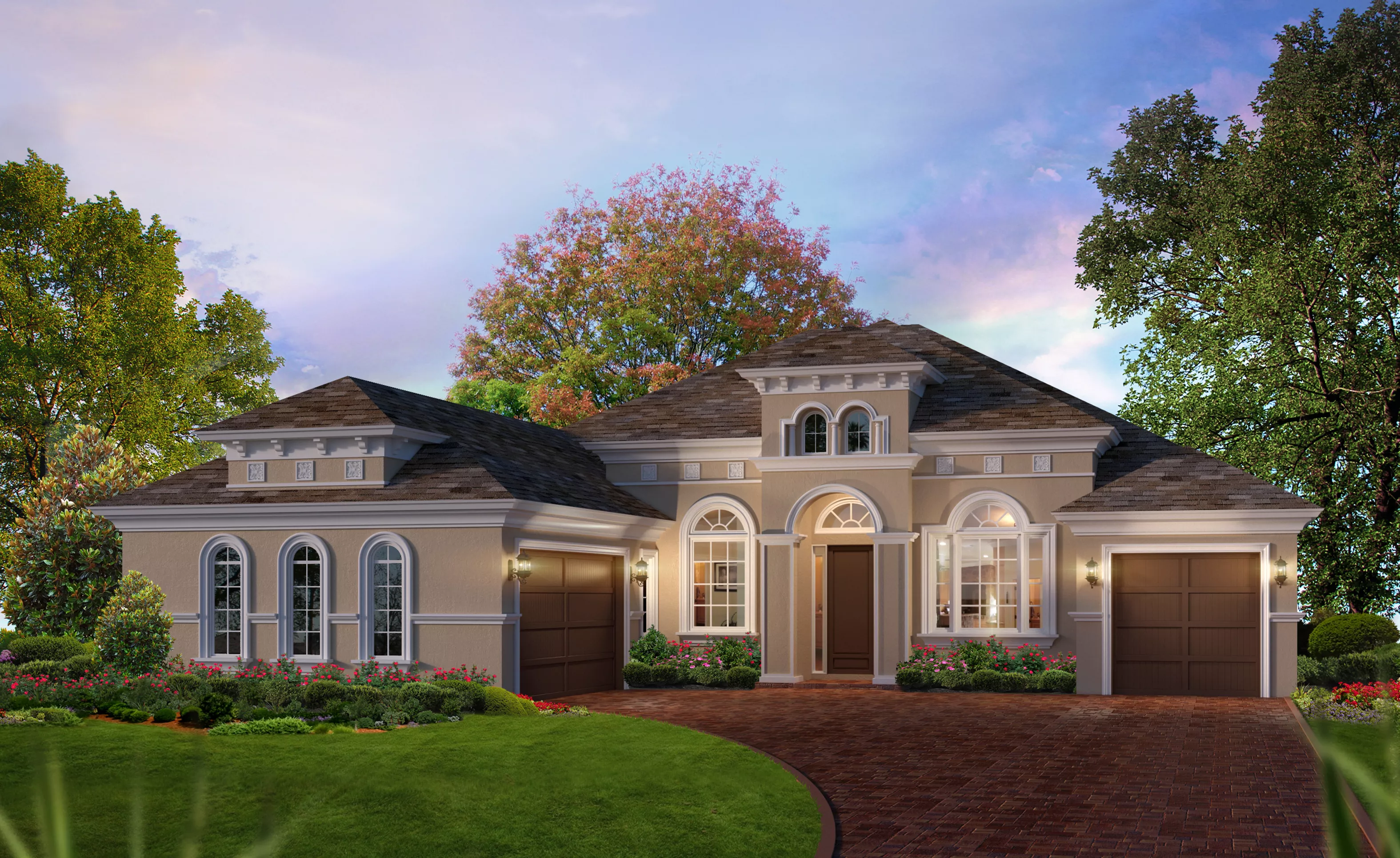Mediterranean exterior of the Egret VII home featuring a tan stucco facade, arched windows, and a brick paver driveway.