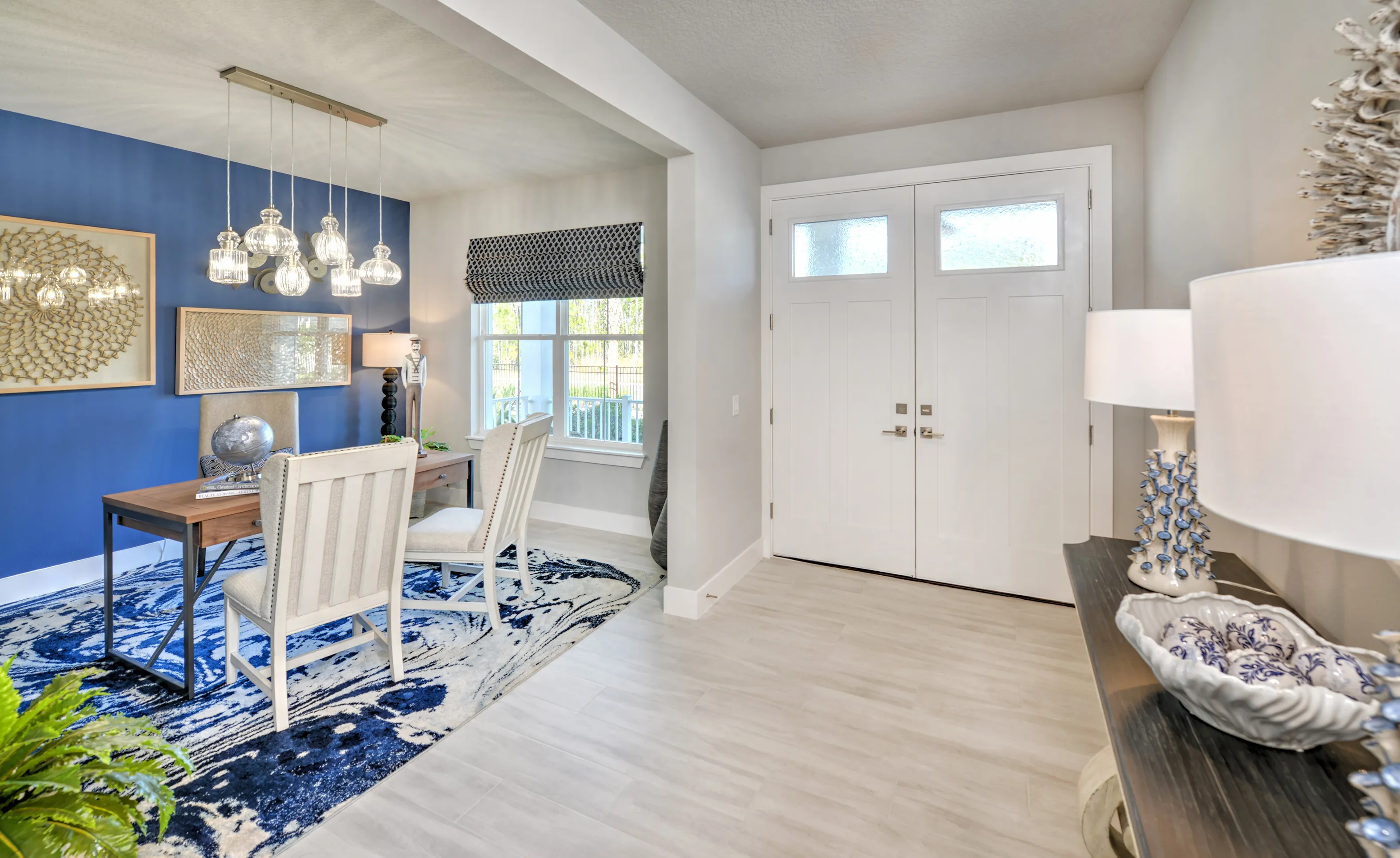 Woodhaven Single Family home entrance with white double doors leading to an office with a blue accent wall and rug.