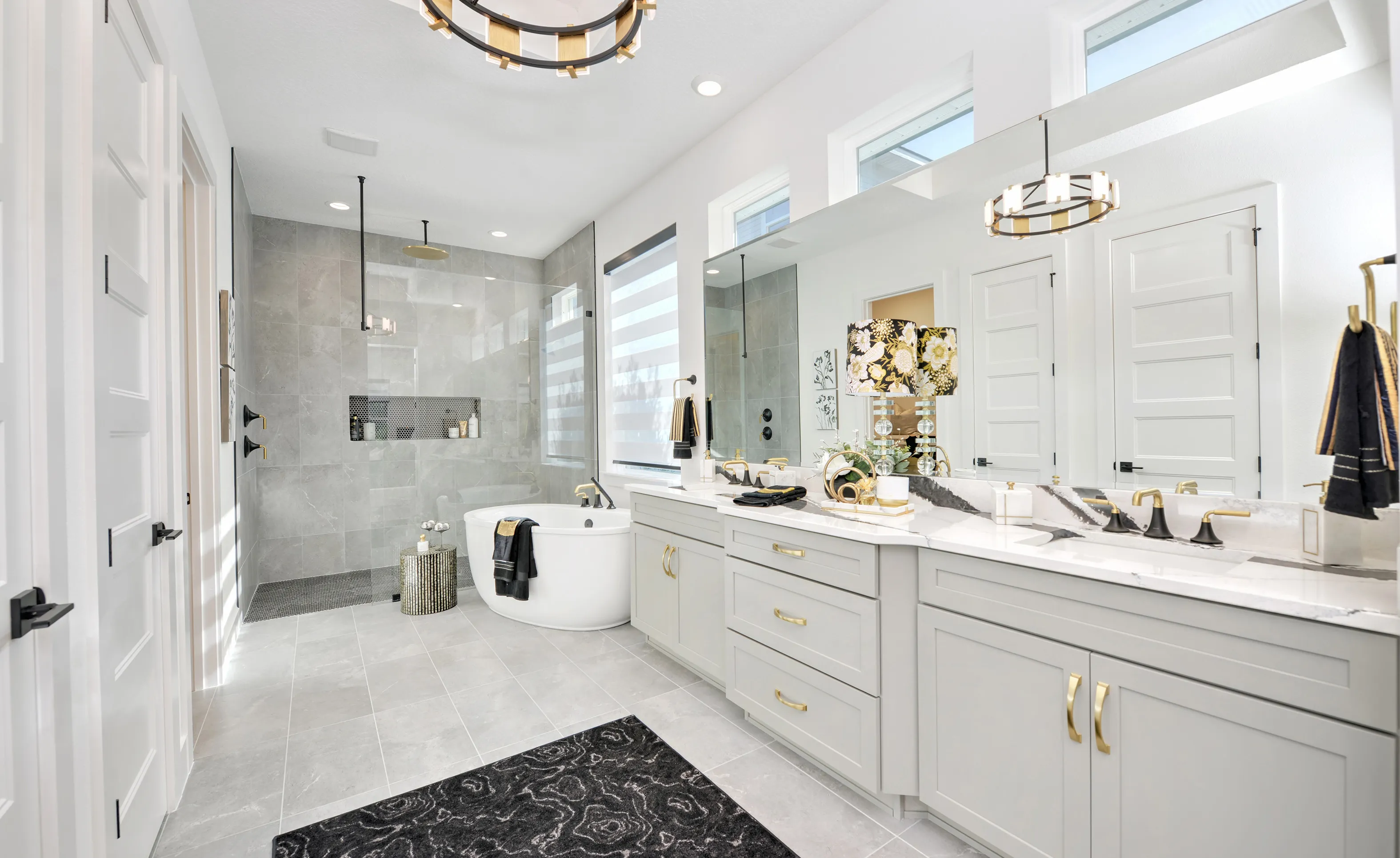 Modern bathroom in Woodhaven Single Family with gray vanity, double sinks, soaking tub, and walk-in glass shower.
