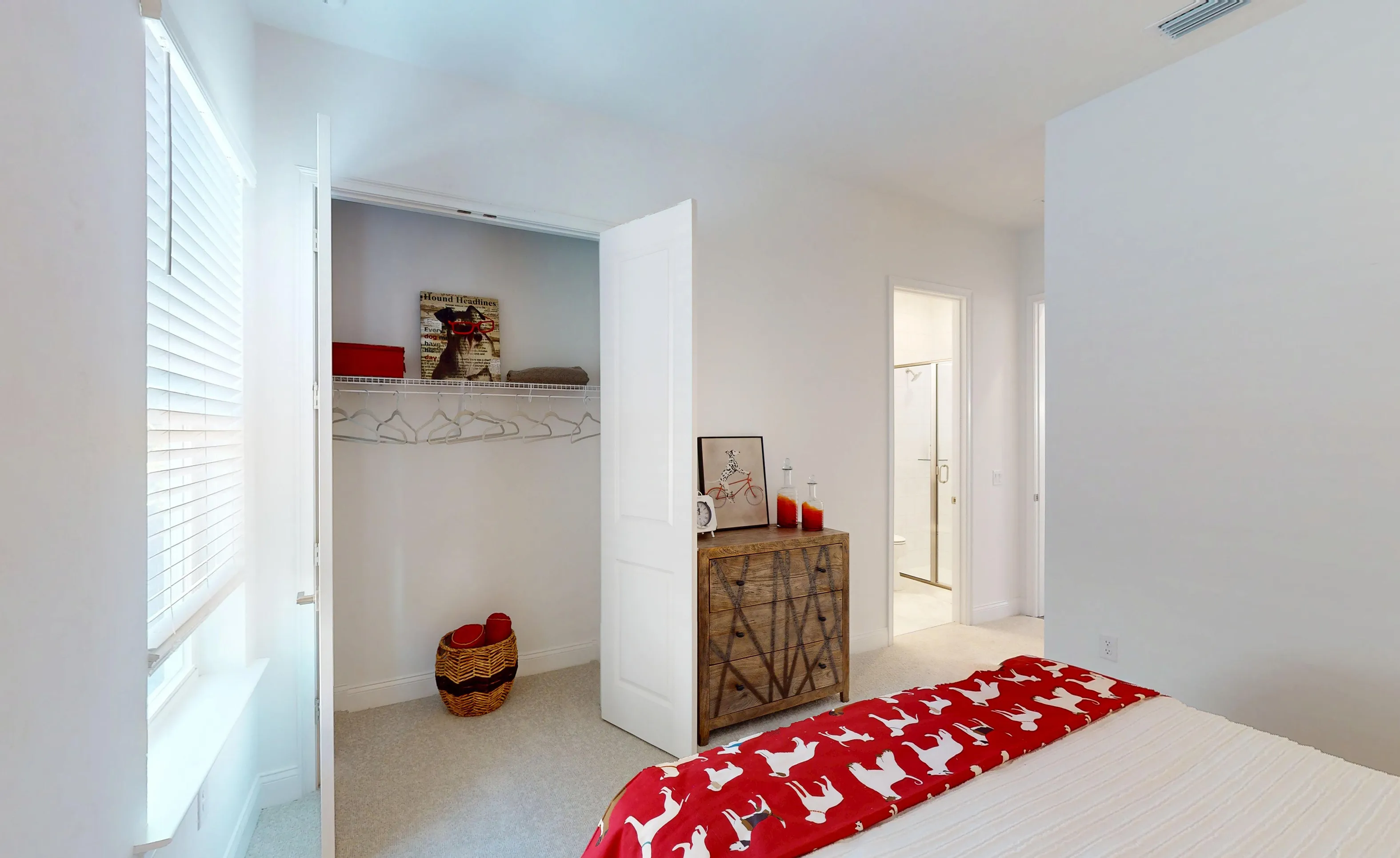 Secondary bedroom in the Kona plan with white walls, carpeted floors, a reach-in closet, and an attached bathroom.