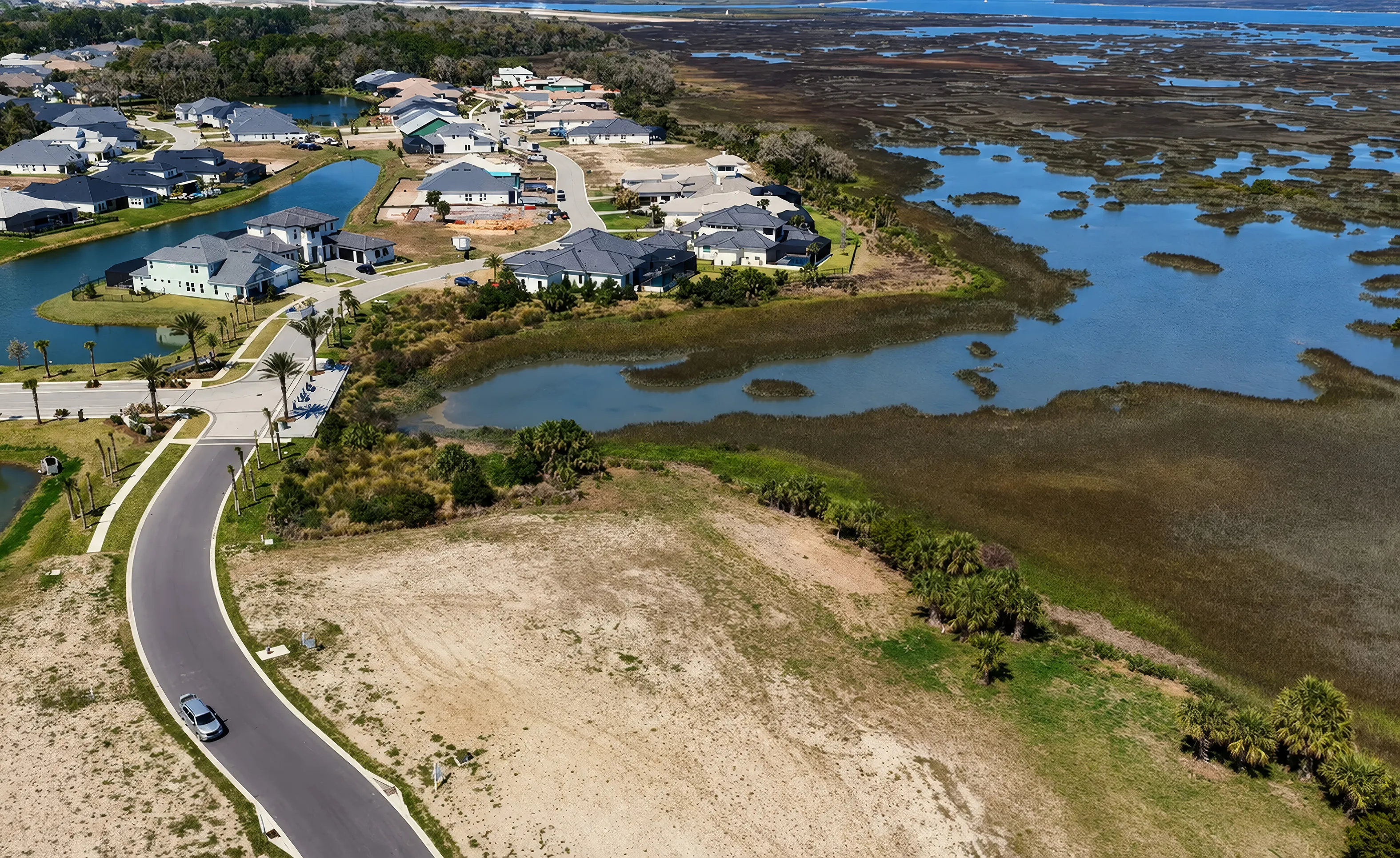 Aerial view of the Madeira at St Augustine community featuring residential streets, houses, and coastal marshland.