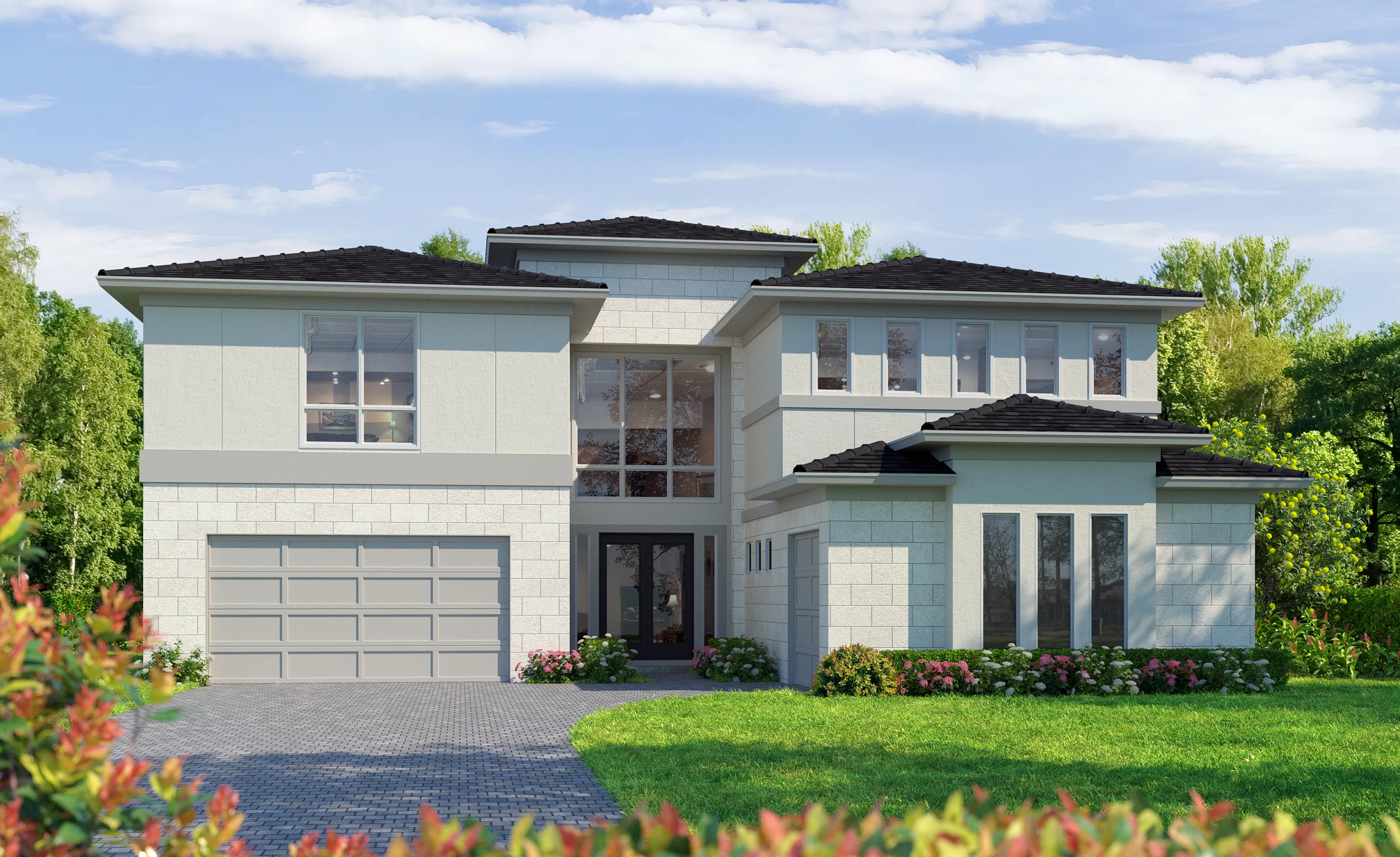 Exterior of the St. Kitts home design with light-colored stone accents, dark tile roof, and a paved driveway.