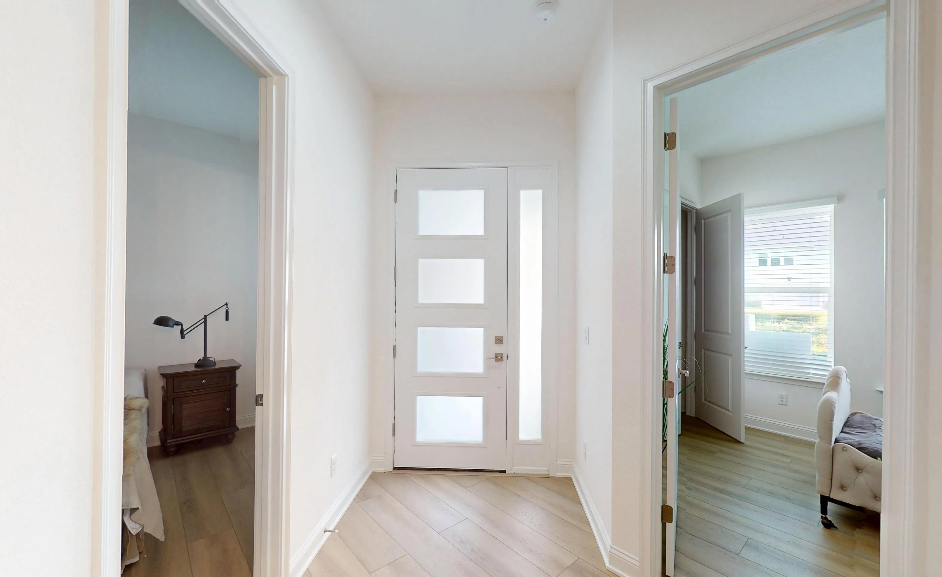 Foyer of the Gulf - G plan in Nocatee featuring a white front door with frosted glass panels and wood-look tile flooring.