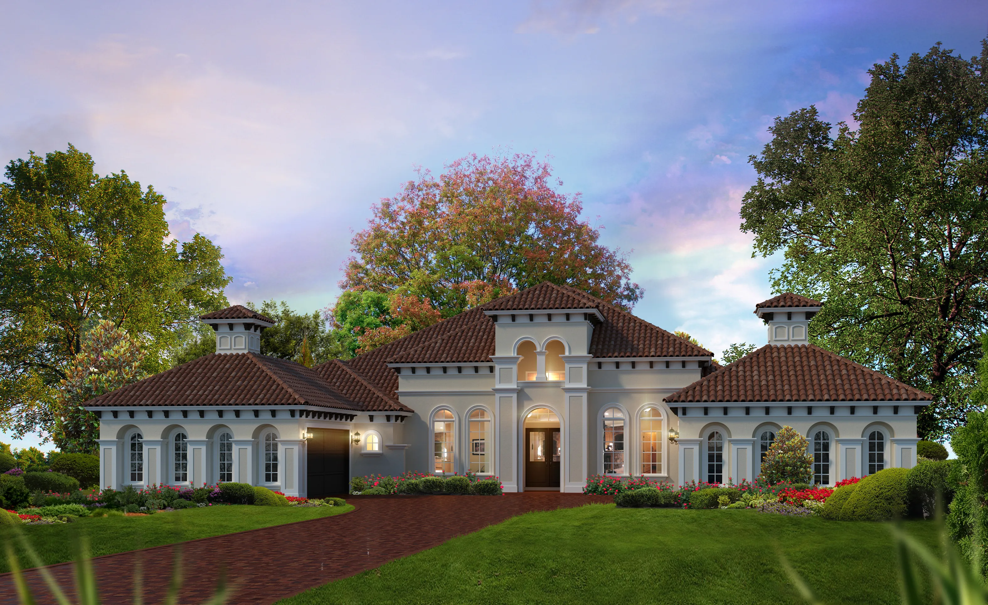 Exterior of the Monaco Mediterranean II home featuring a stucco facade, red tile roof, arched windows, and a brick driveway.